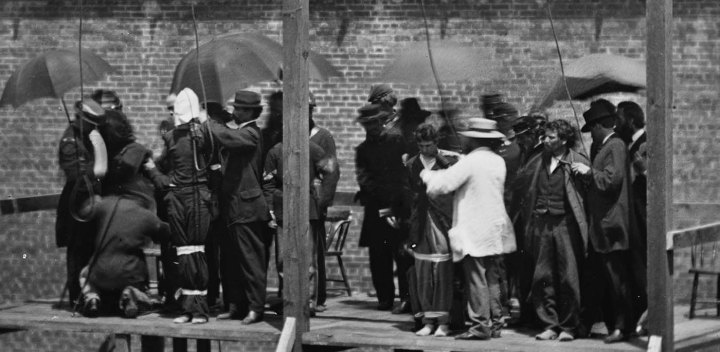 [Credit: Close-up of Lincoln conspirators prior to execution. Far left in the hood is the first woman to be executed by the US Federal Government/Alexander Gardner.]